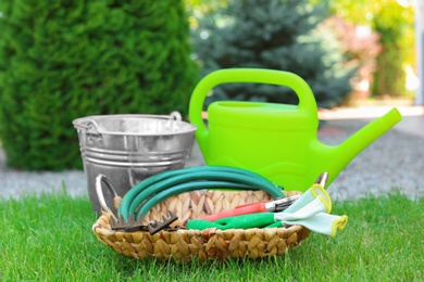 Photo of Set of gardening tools on green grass