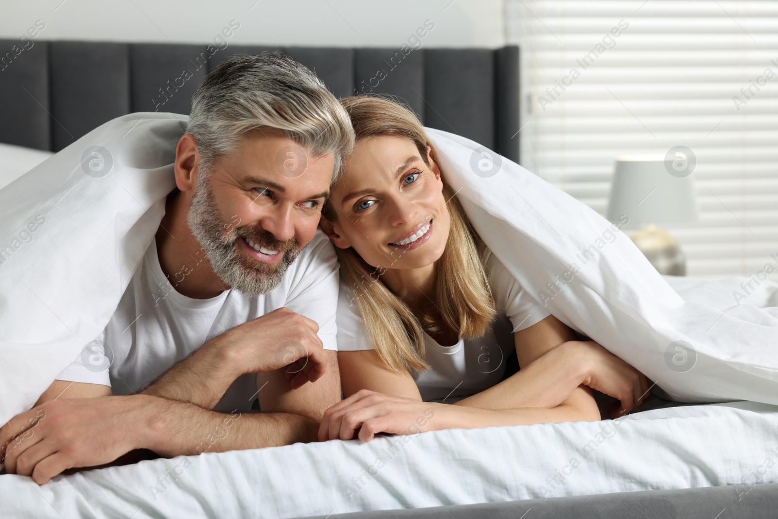 Photo of Lovely mature couple in bed at home