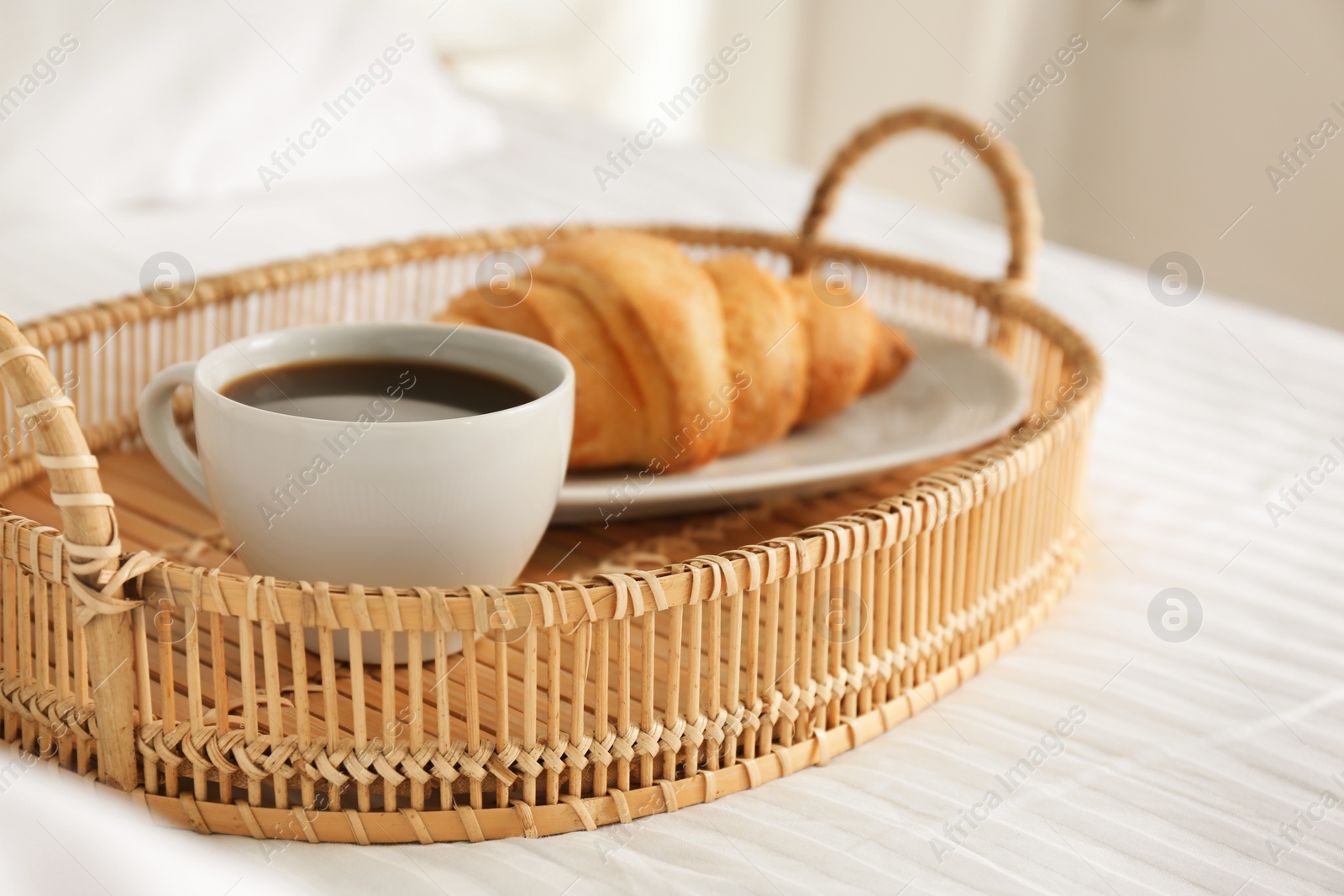 Photo of Tray with tasty breakfast on bed. Cozy morning