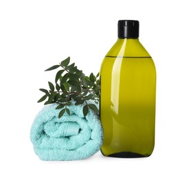 Photo of Bottle of shampoo and terry towel on white background