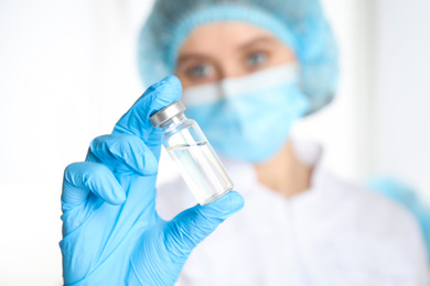 Photo of Doctor holding vial with medication, closeup. Vaccination and immunization