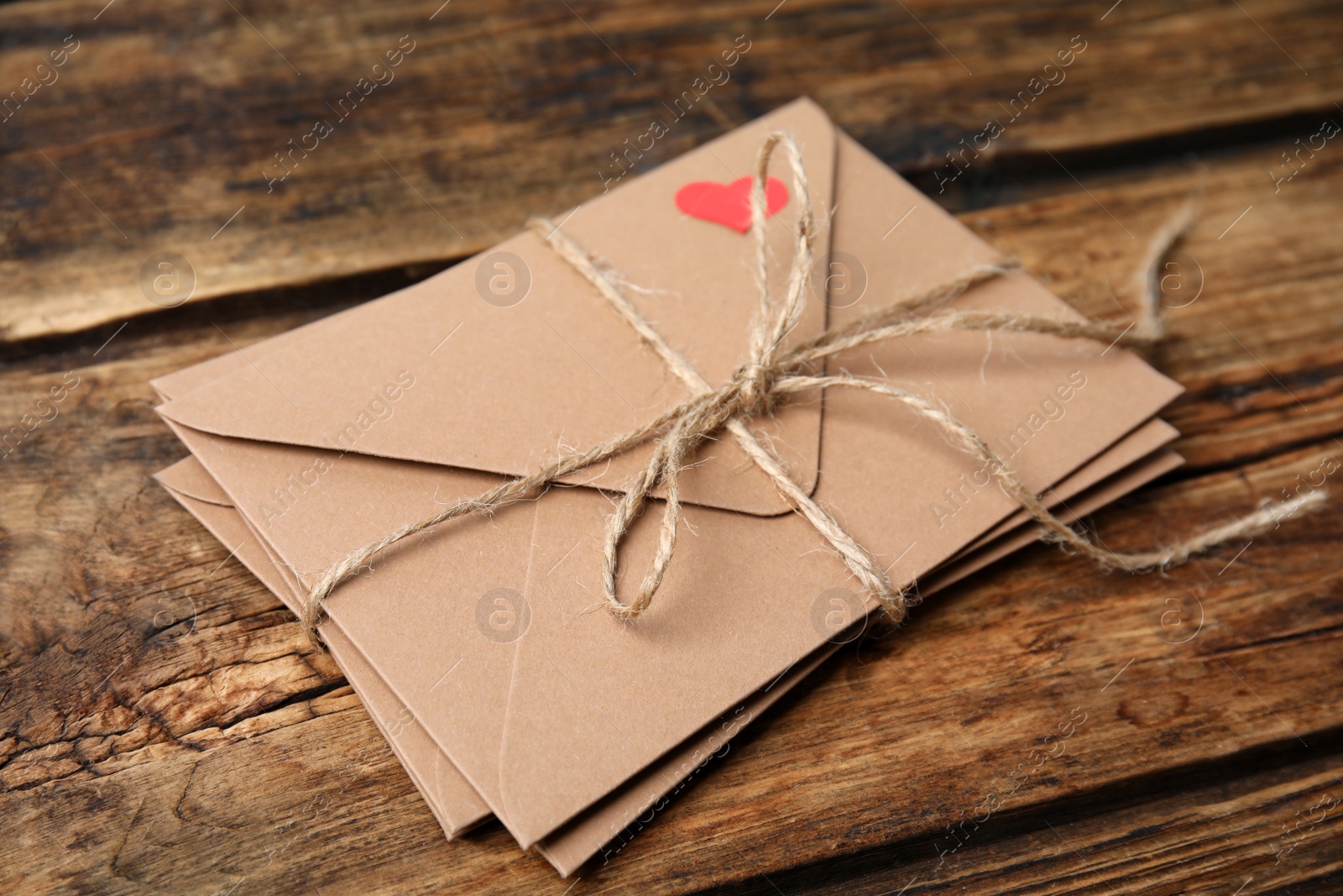 Photo of Stack of envelopes on wooden table. Love letters