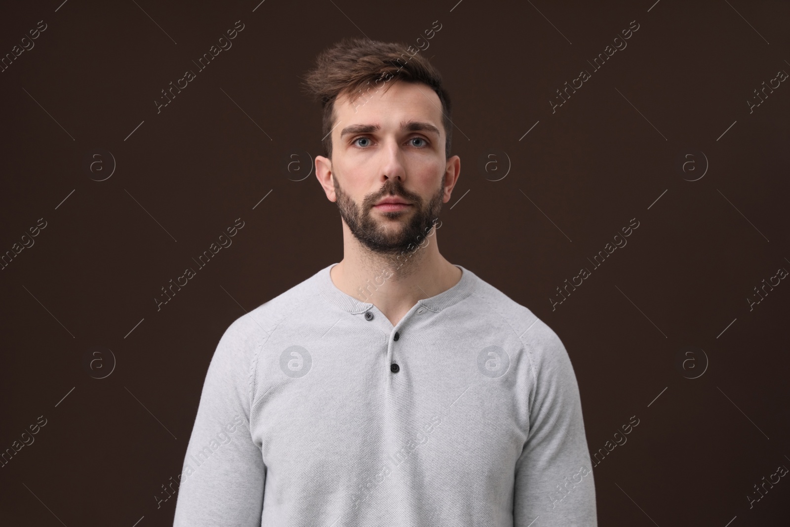 Photo of Portrait of handsome man on brown background