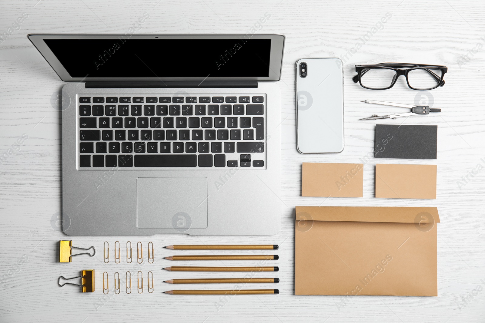 Photo of Flat lay composition with stationery on white wooden background. Mock up for design