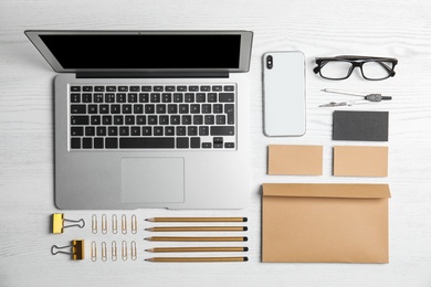 Flat lay composition with stationery on white wooden background. Mock up for design