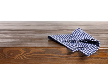 Photo of Checkered tablecloth on wooden table against white background