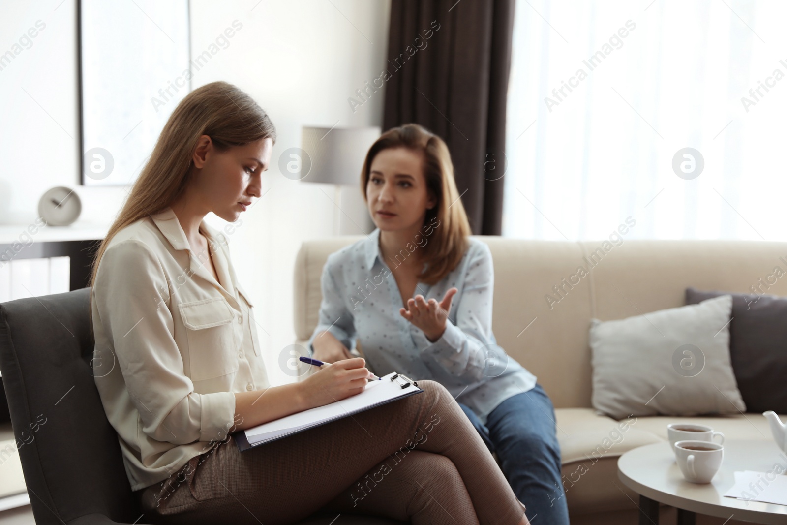 Photo of Professional psychotherapist working with patient in office