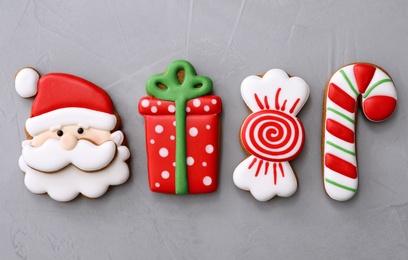 Photo of Different Christmas gingerbread cookies on grey background, flat lay