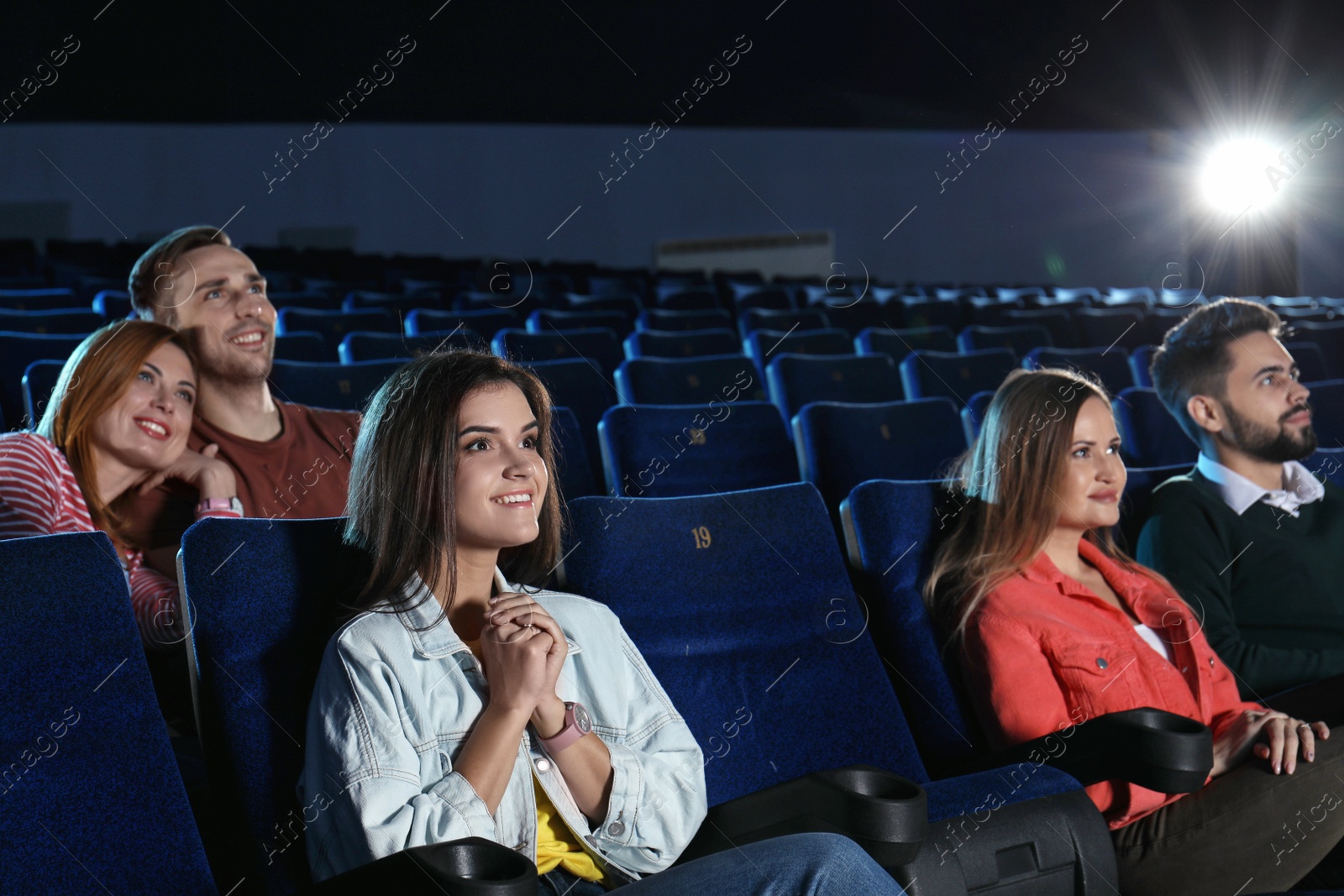 Photo of Young people watching movie in cinema theatre