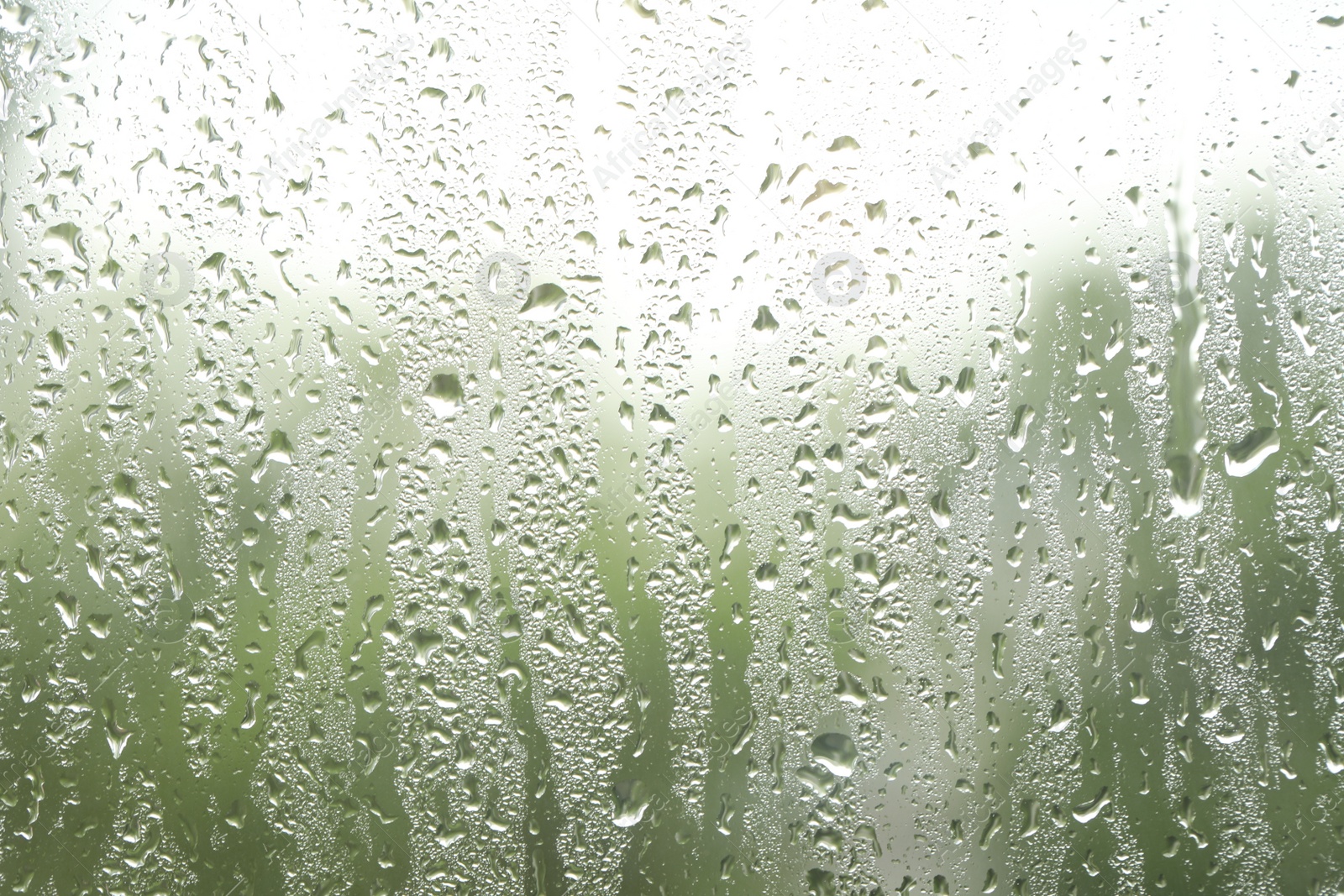 Photo of Window glass with raindrops as background, closeup