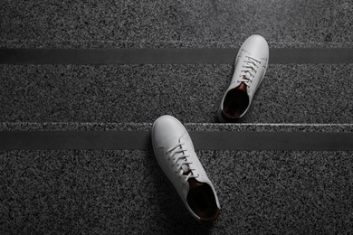 Photo of Pair of stylish sports shoes on stairs, top view