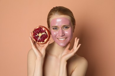 Photo of Young woman with pomegranate face mask and fresh fruit on pale coral background