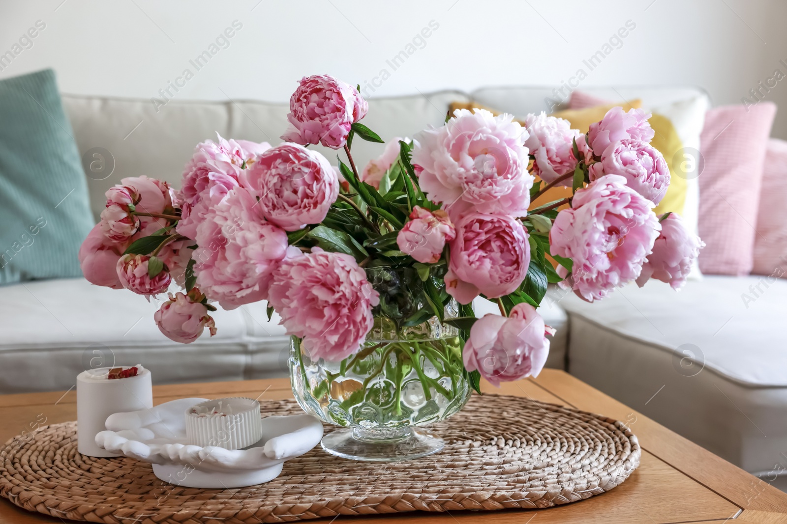 Photo of Beautiful pink peonies in vase on table at home. Interior design