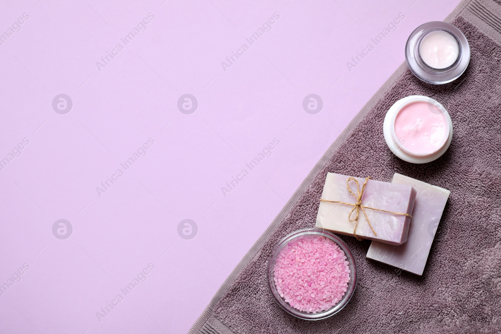 Photo of Different cosmetic products on lilac background, flat lay. Space for text