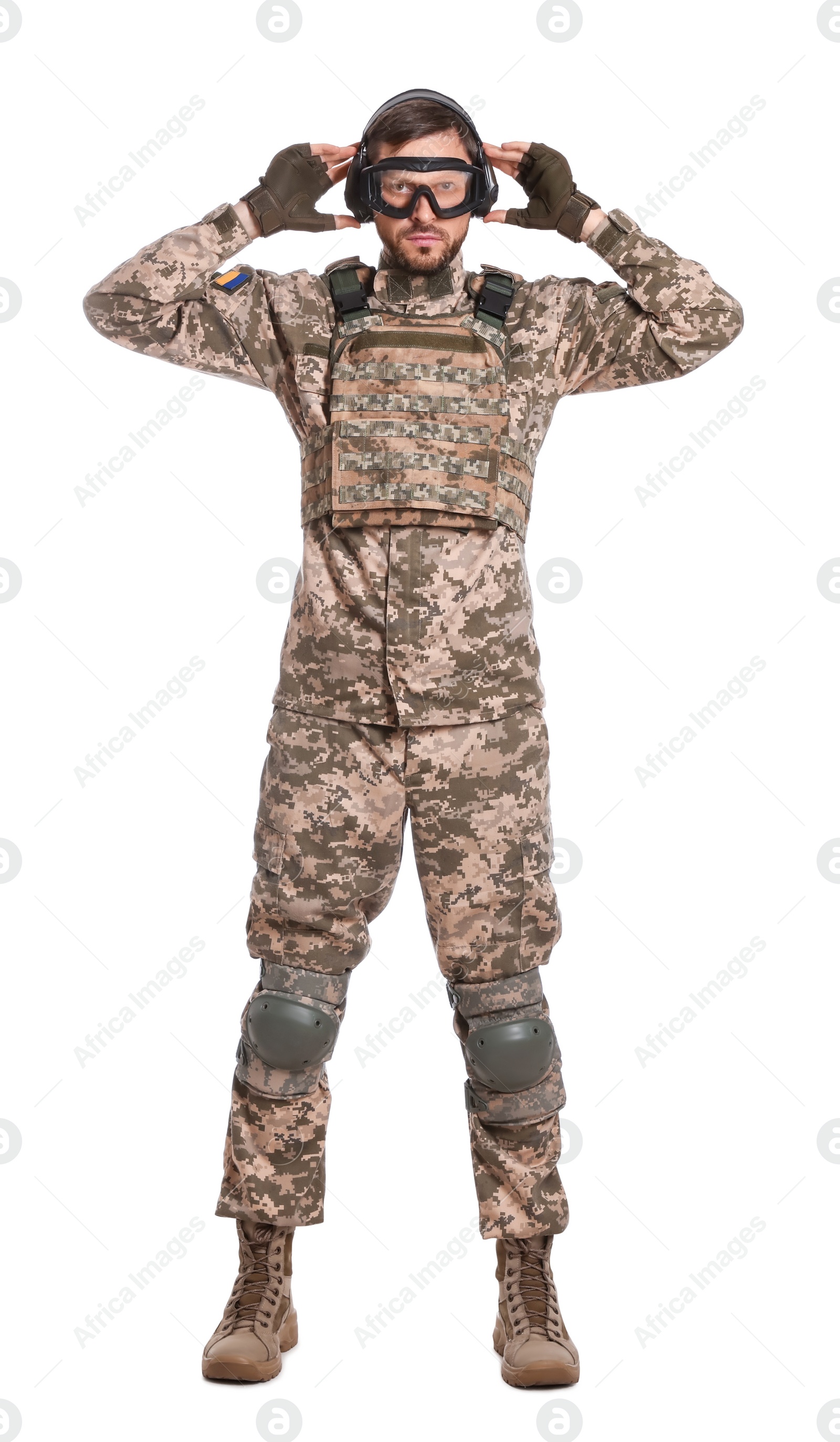 Photo of Soldier in Ukrainian military uniform, tactical goggles and headphones on white background