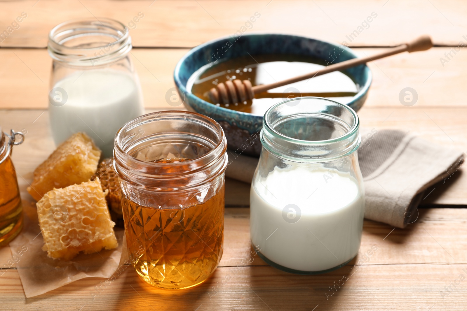 Photo of Composition with milk and honey on wooden background