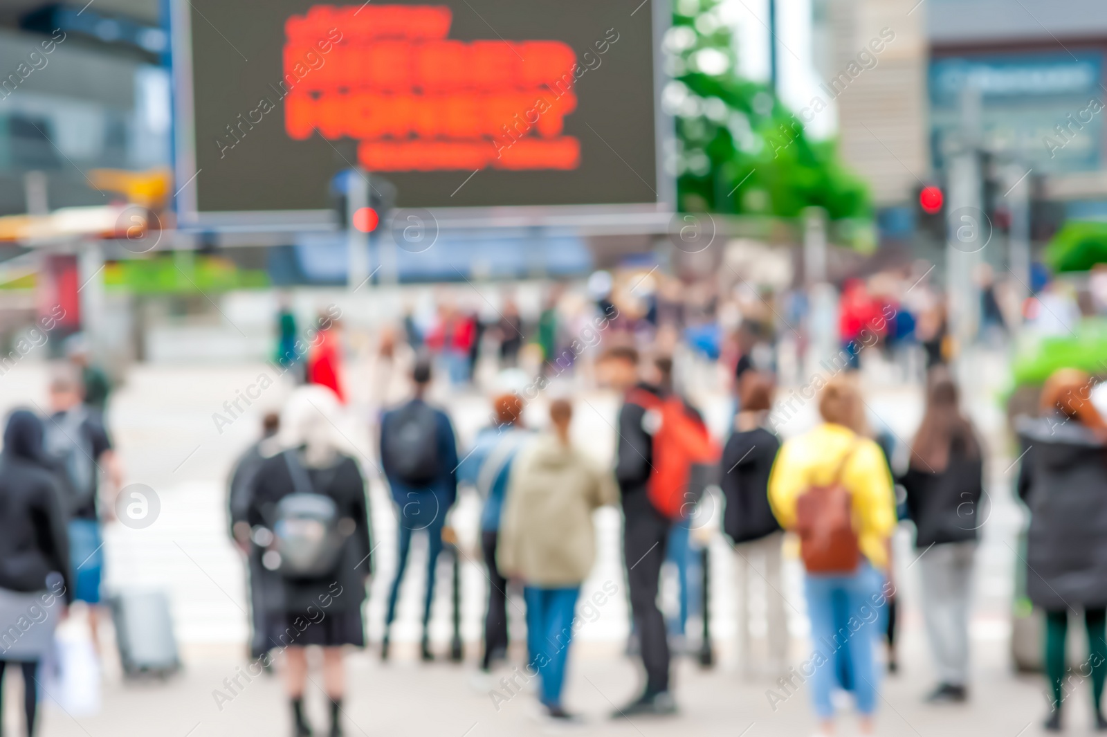 Photo of People waiting to cross street in city, blurred view