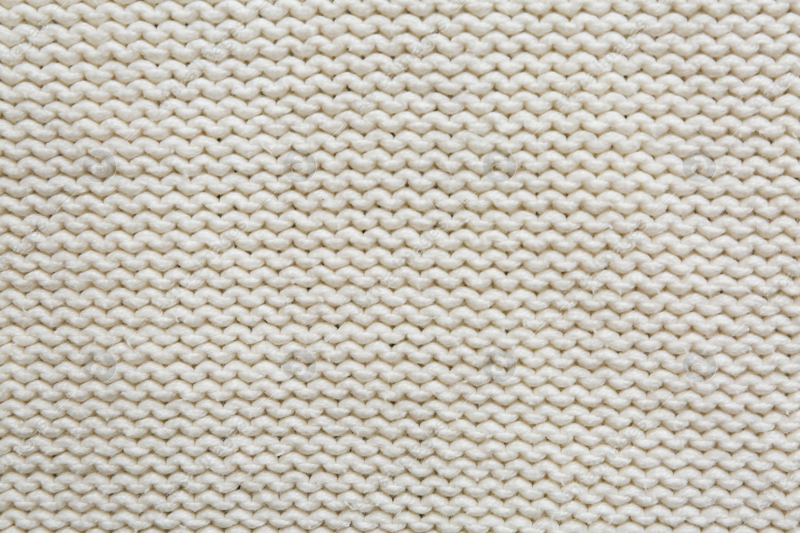 Photo of Beautiful white knitted fabric as background, top view