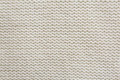 Photo of Beautiful white knitted fabric as background, top view