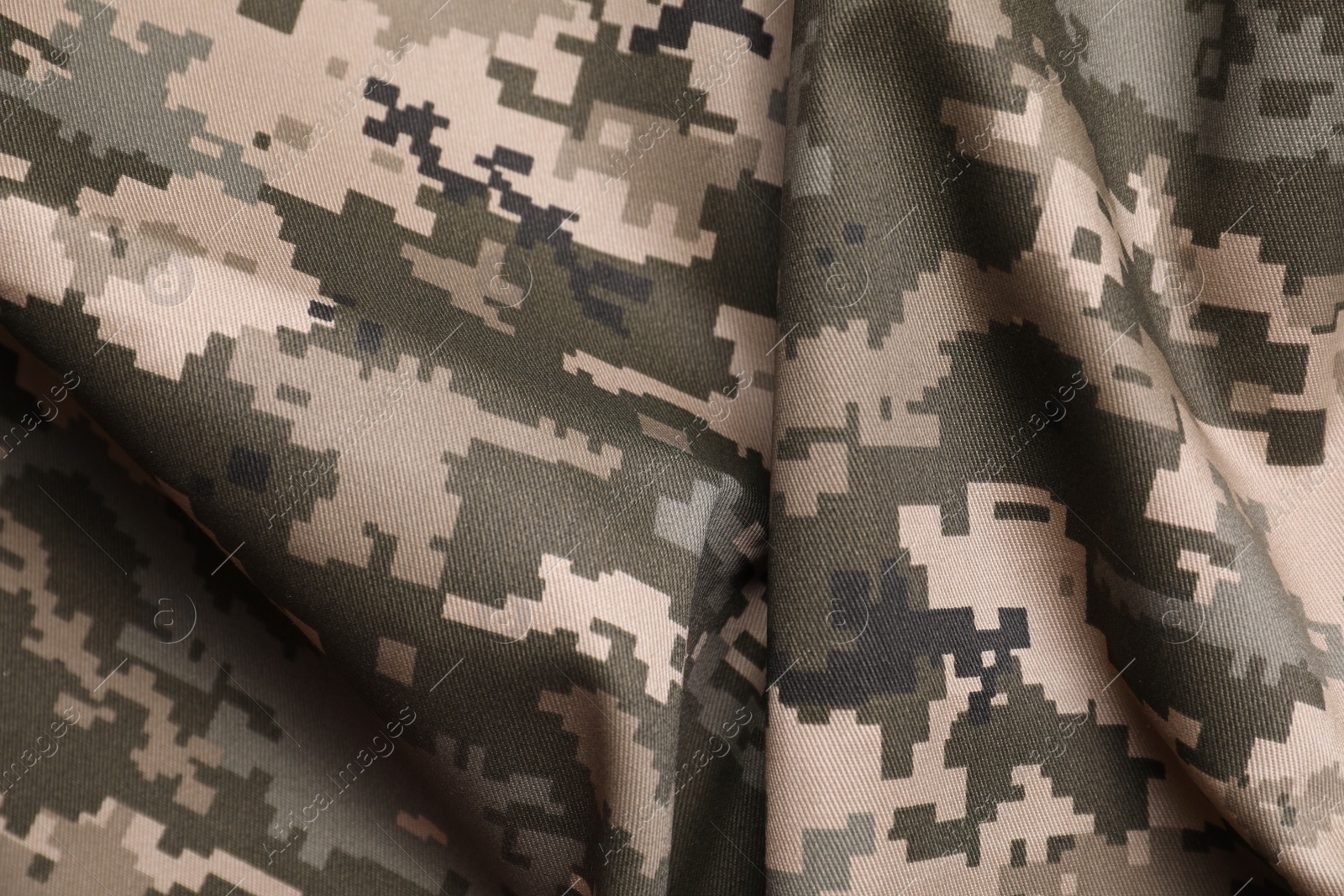 Photo of Texture of crumpled camouflage fabric as background, top view