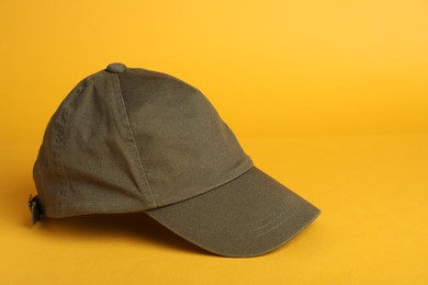Photo of Baseball cap on yellow background, space for text