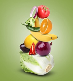 Image of Stack of different vegetables and fruits on pale yellow green background