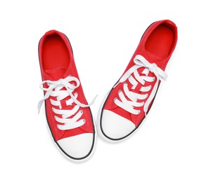 Photo of Pair of red classic old school sneakers isolated on white, top view