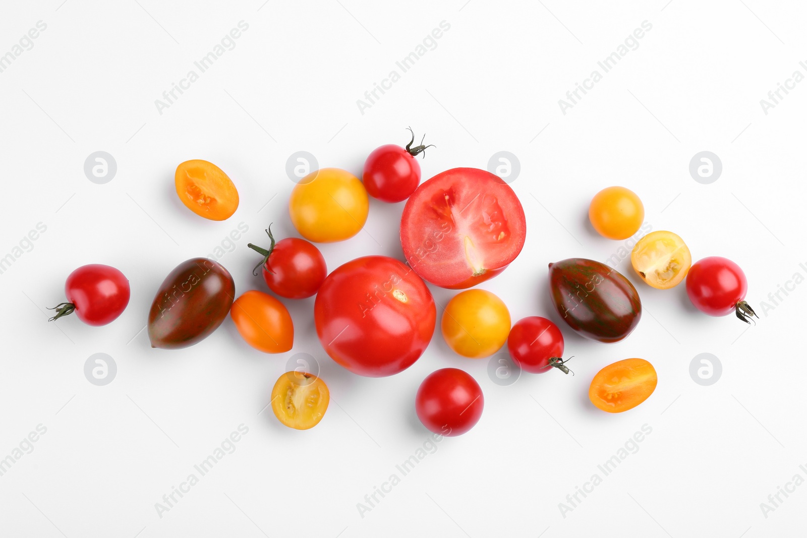 Photo of Flat lay composition with different whole and cut tomatoes on white background