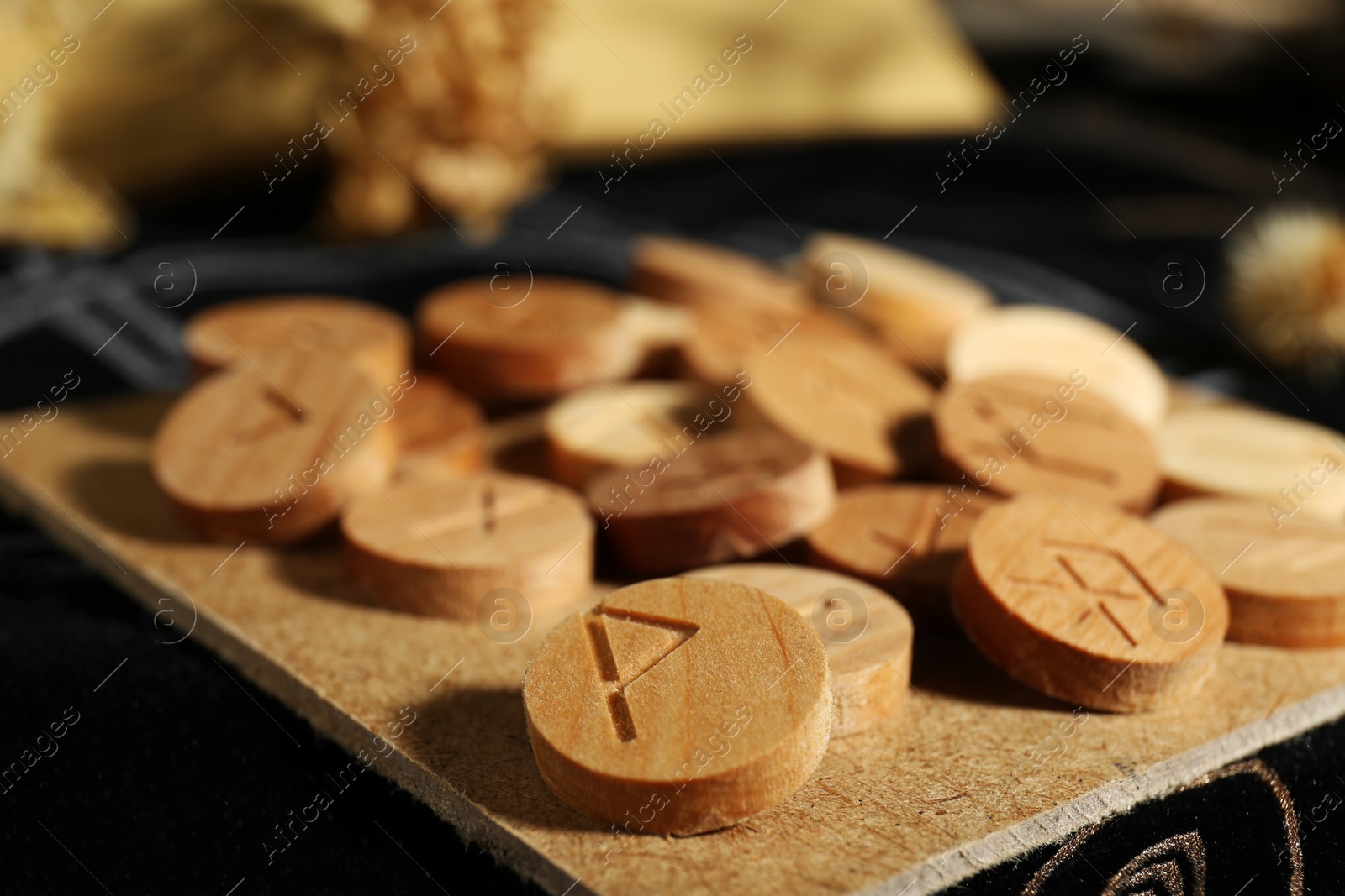 Photo of Many wooden runes on divination mat, closeup
