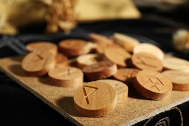 Many wooden runes on divination mat, closeup