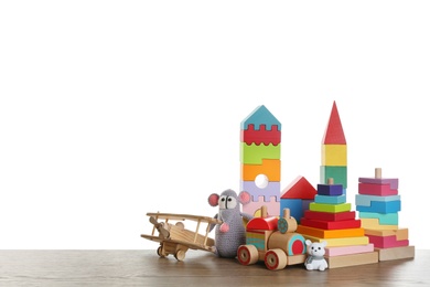 Set of different toys on wooden table against white background. Space for text