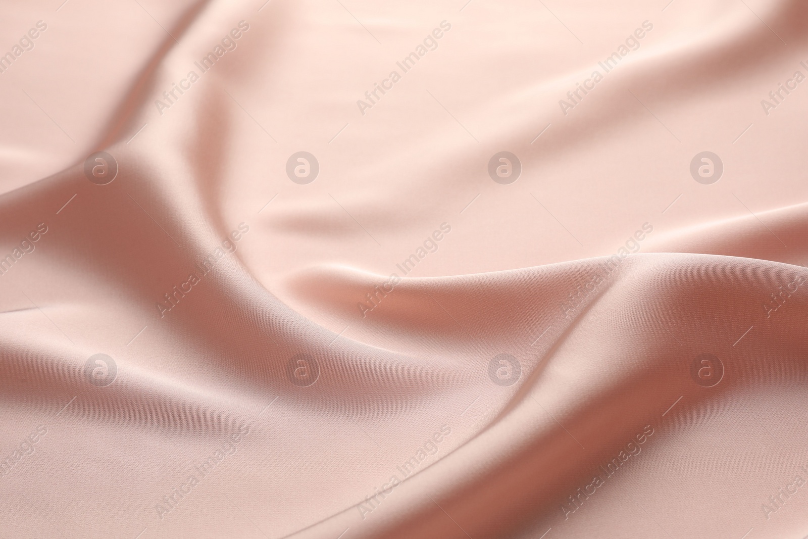 Photo of Crumpled pink silk fabric as background, closeup