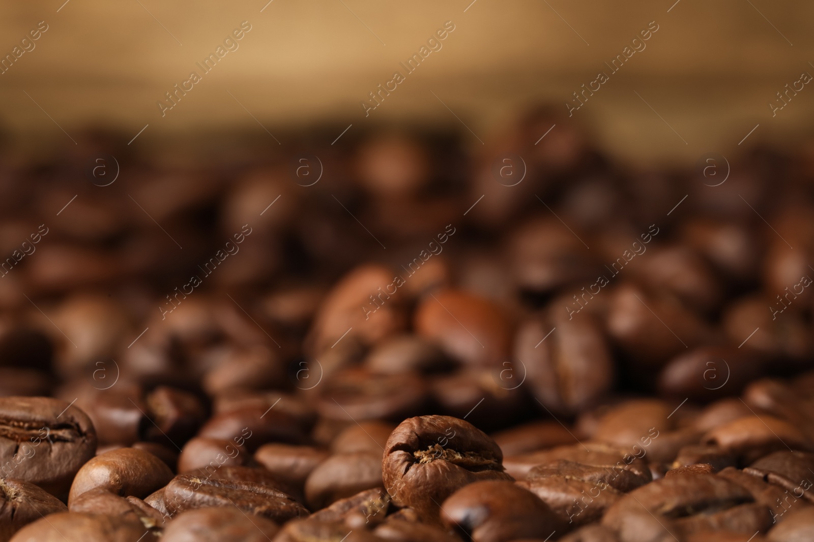 Photo of Heap of aromatic roasted coffee beans, closeup