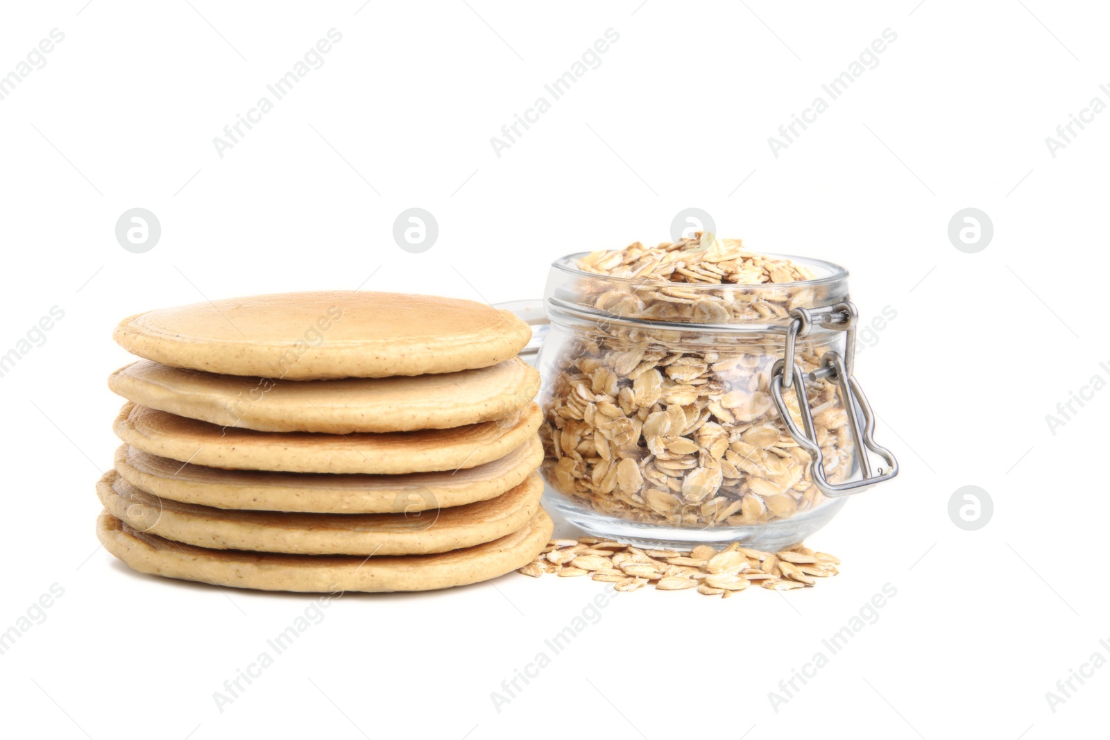 Photo of Tasty oatmeal pancakes and flakes on white background