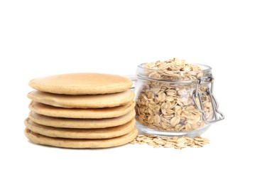 Photo of Tasty oatmeal pancakes and flakes on white background