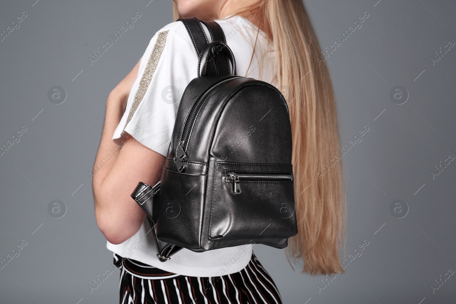 Photo of Woman with stylish backpack on grey background