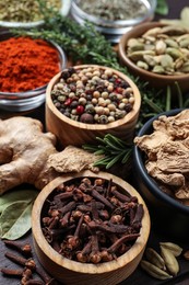 Photo of Different natural spices and herbs on table, closeup