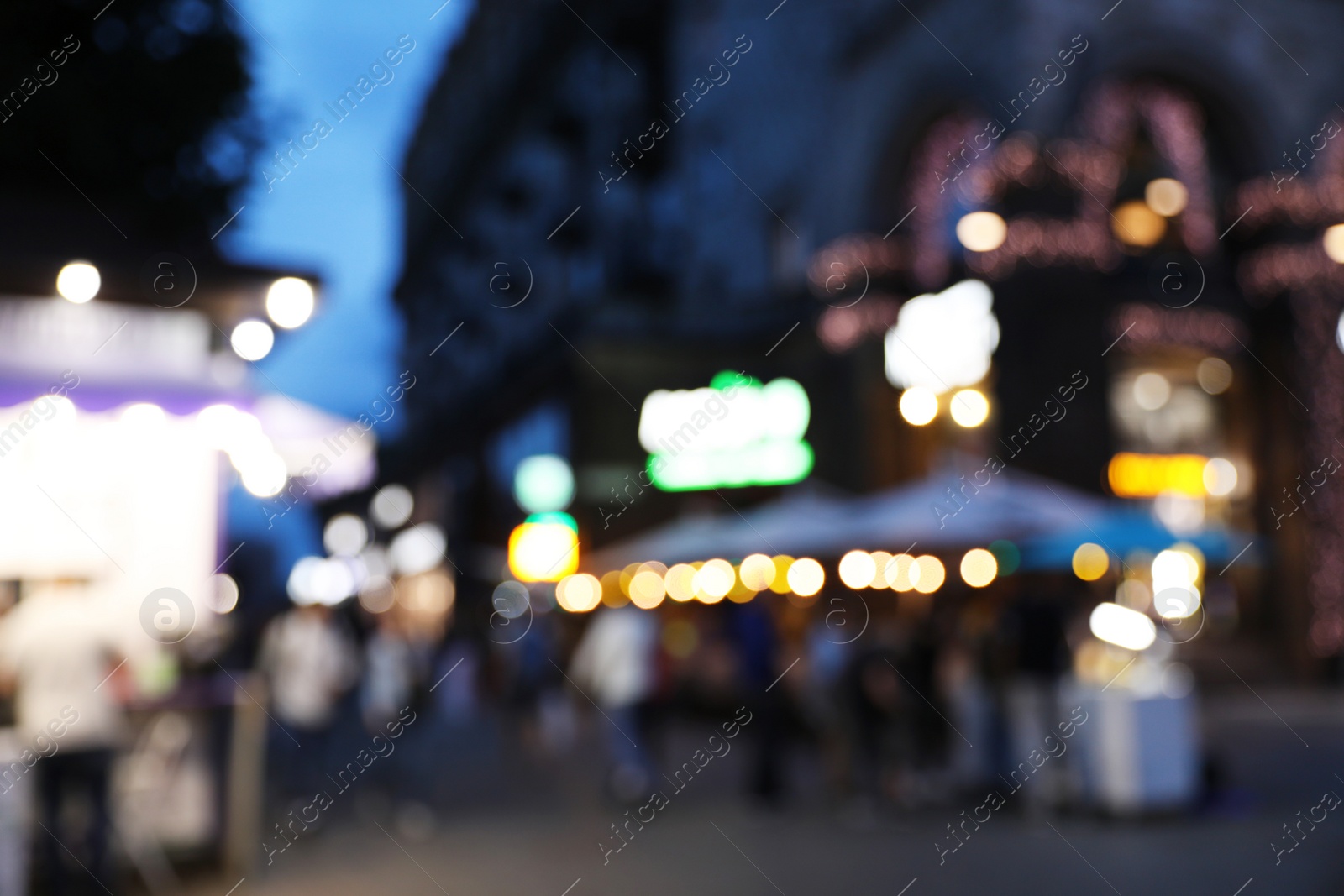 Photo of Blurred view of modern city at evening. Bokeh effect