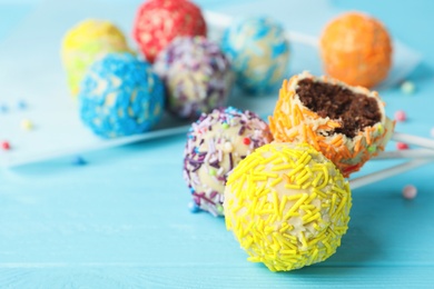 Photo of Yummy colorful cake pops on table, closeup. Space for text