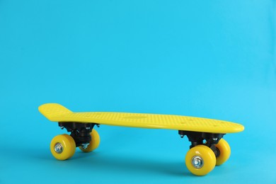 Photo of Yellow skateboard on light blue background. Space for text