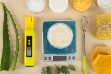 Flat lay composition with homemade cosmetic products and fresh ingredients on beige background