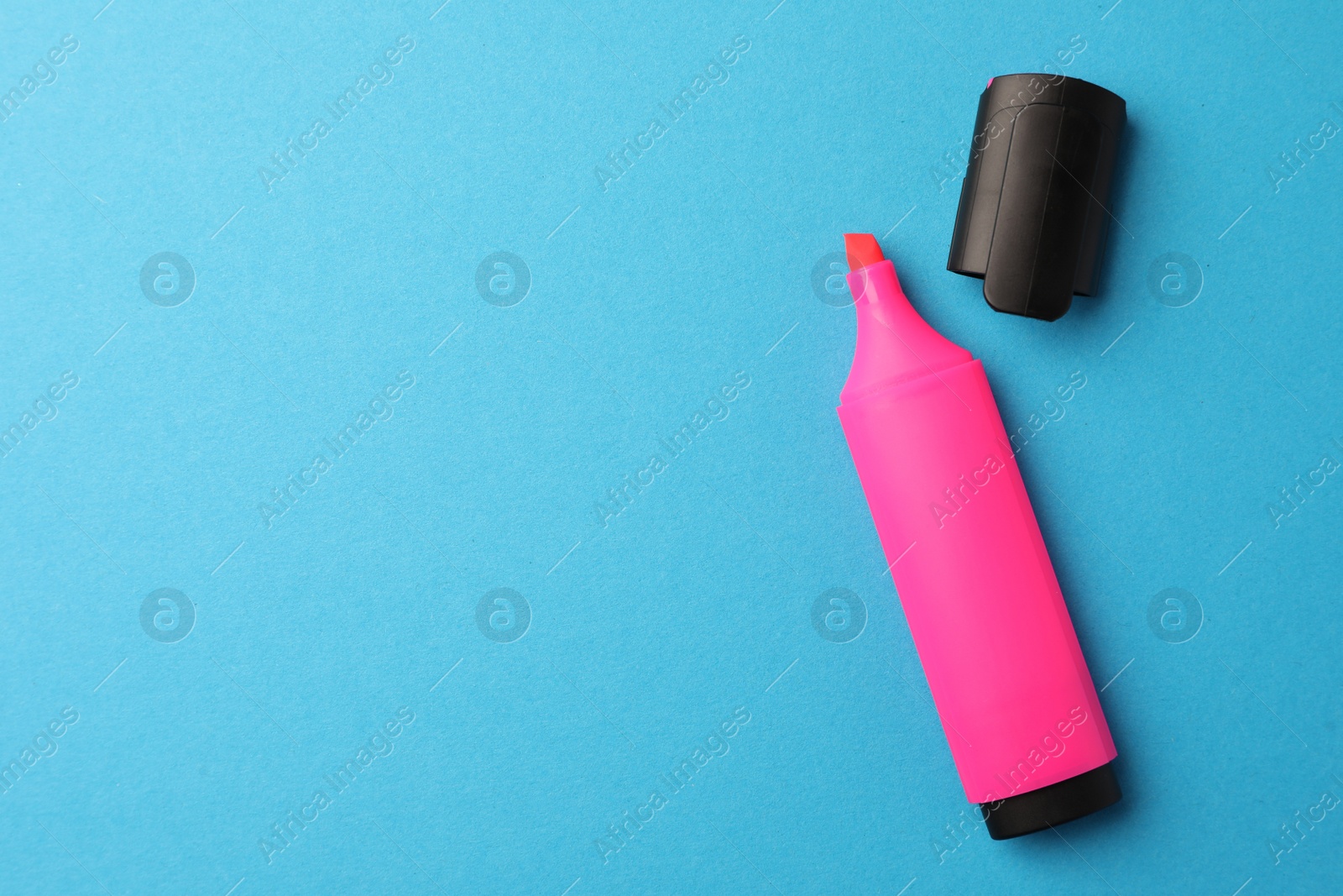 Photo of Bright pink marker on light blue background, flat lay. Space for text
