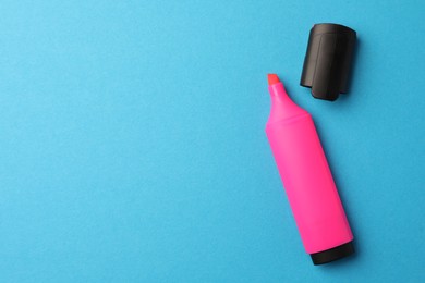 Photo of Bright pink marker on light blue background, flat lay. Space for text