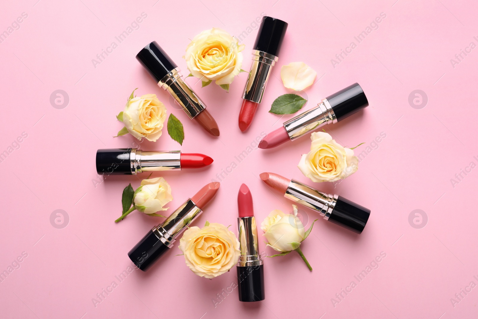 Photo of Flat lay composition with lipsticks and roses on color background