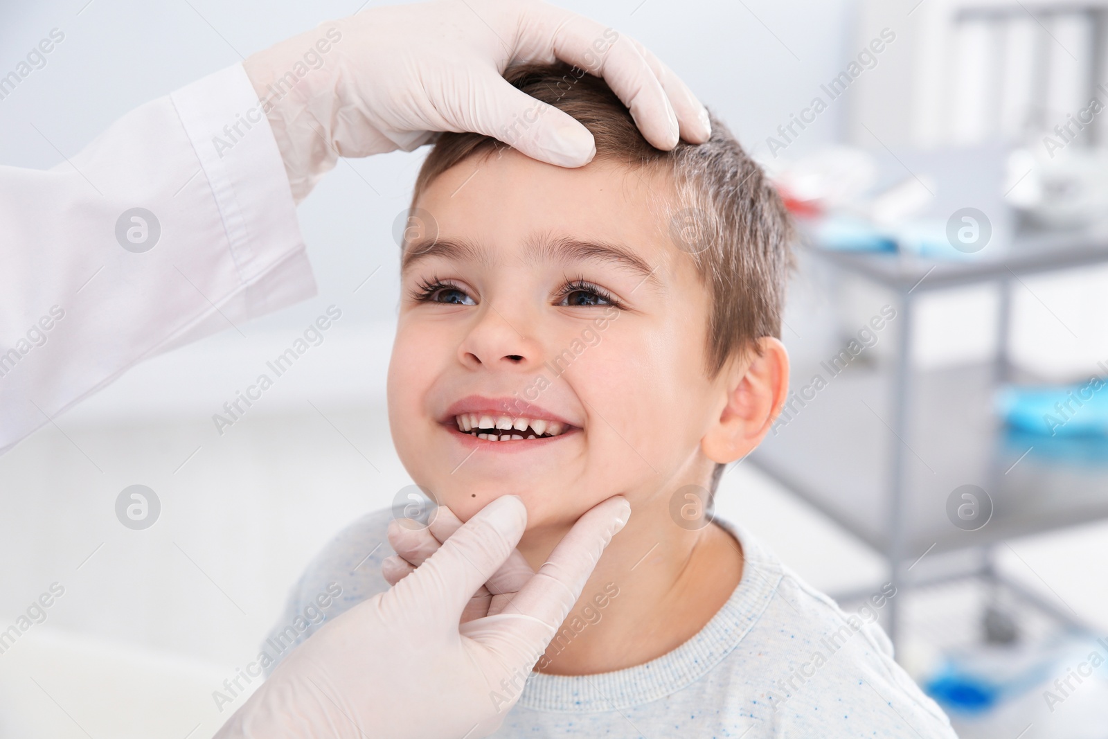 Photo of Dermatologist examining little boy's birthmark in clinic