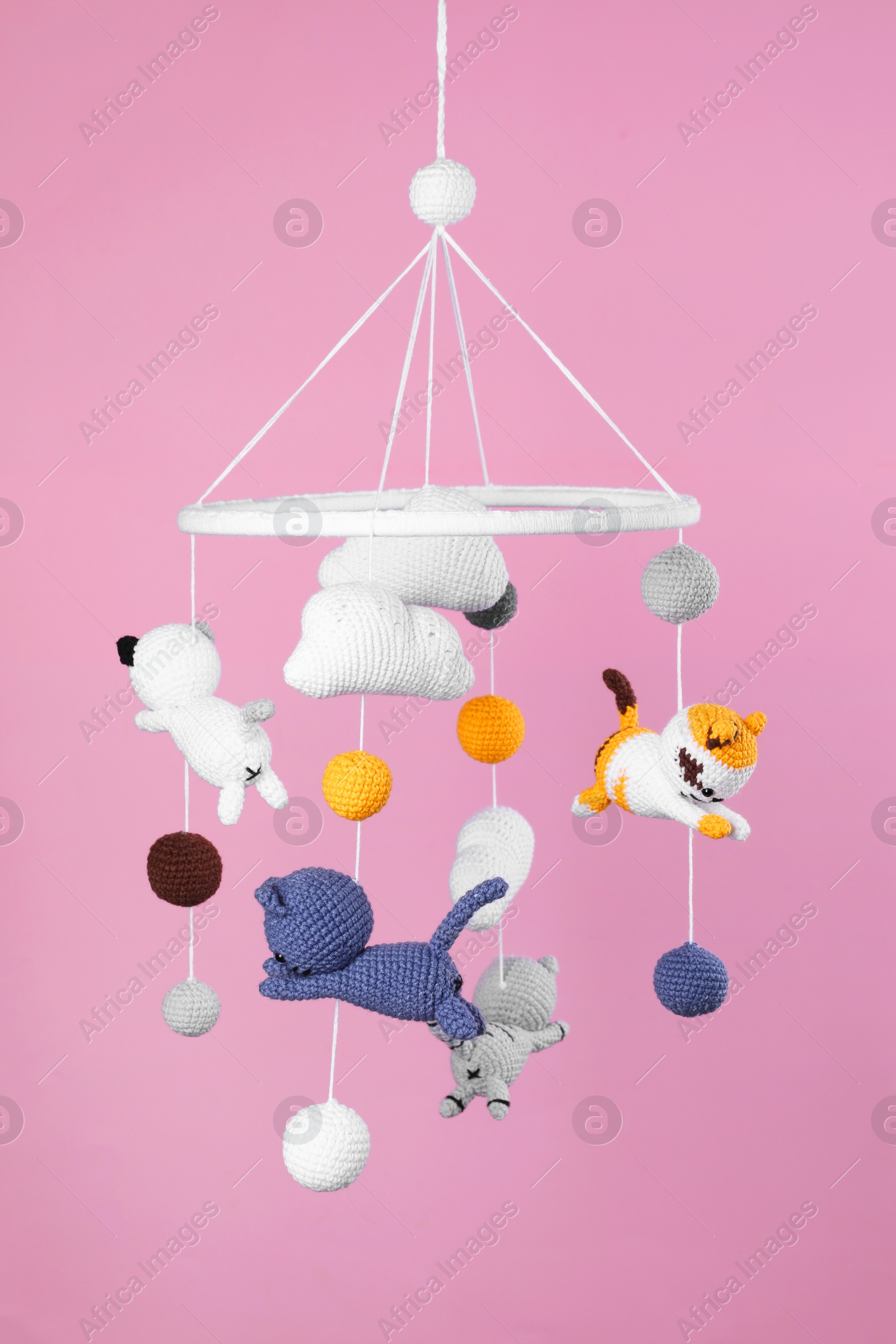 Photo of Cute baby crib mobile on pink background