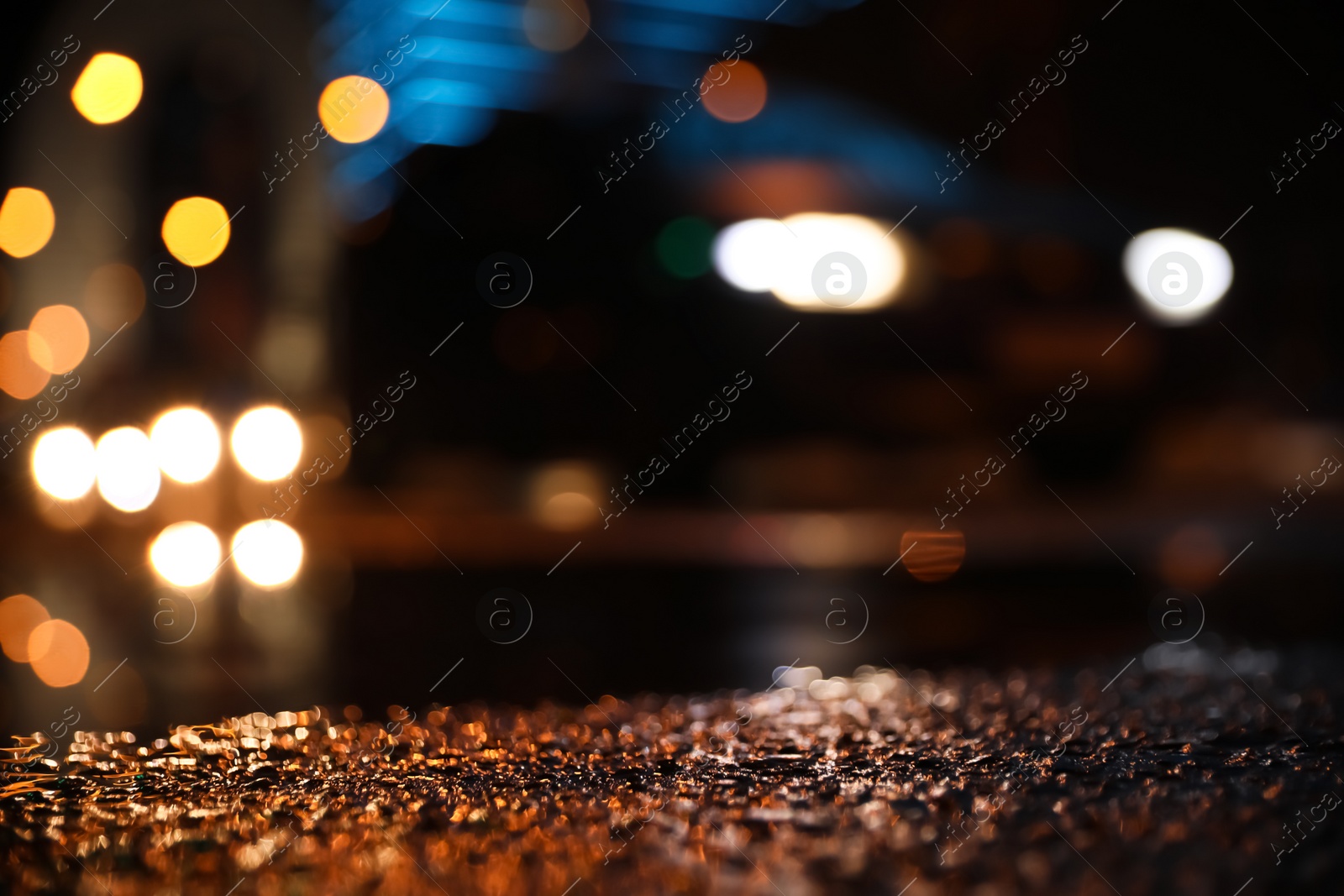 Photo of View of cityscape with bokeh effect, focus on asphalt. Night life