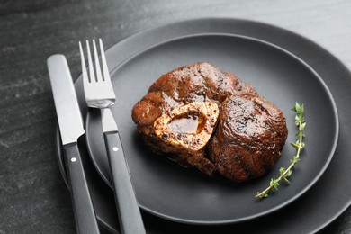 Photo of Tasty grilled beef meat served on black table, closeup