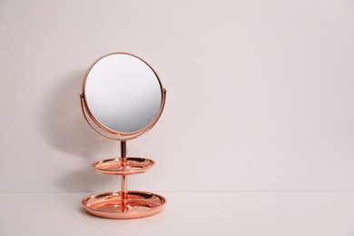 Photo of Stylish mirror with stand on white background, space for text