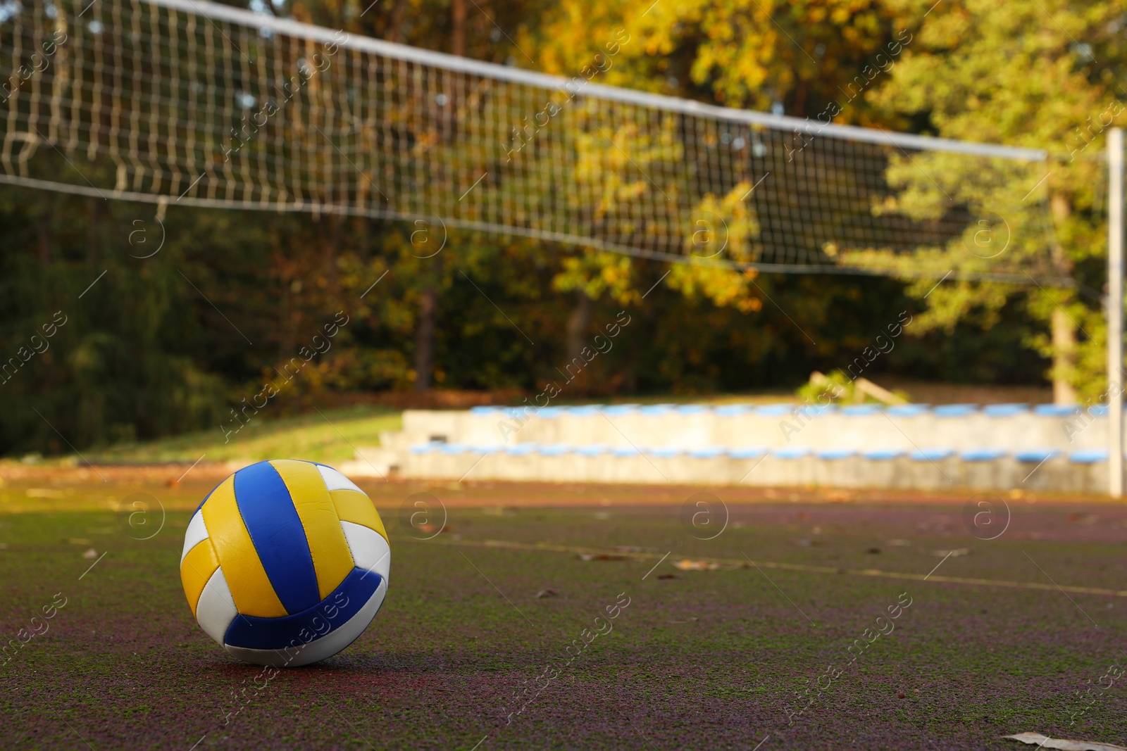 Photo of View of colorful ball on volleyball court outdoors